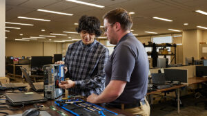 Youth rebuilding a computer in a classroom