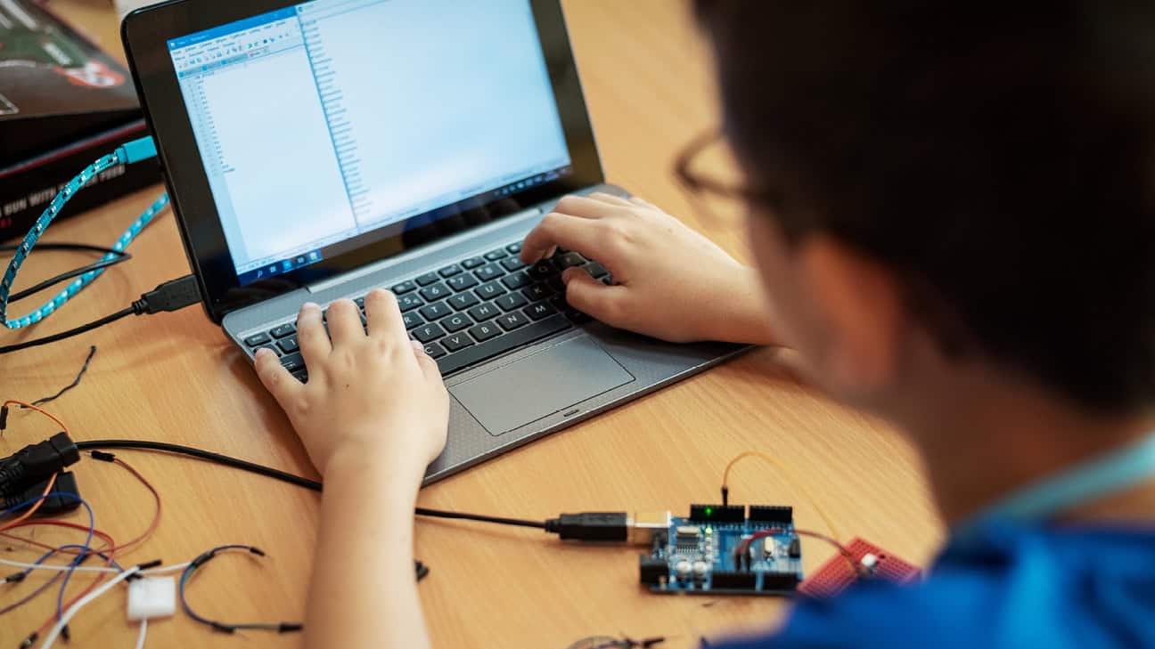 Youth coding on a laptop