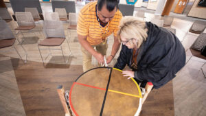 Weylin and Sharon Thompson set up the drum for the drum circle recovery group