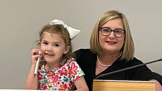 Sara-Jane Smallwood-Cocke and daughter Jane at her city council seat after swearing-in ceremony