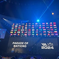 A big screen that says Parade of Nations 2024 showcases flags from across the globe, including the Choctaw flag.