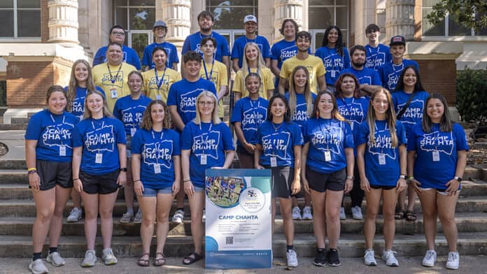 A group of college freshmen gather wearing blue Southeastern shirts for Camp Chahta.