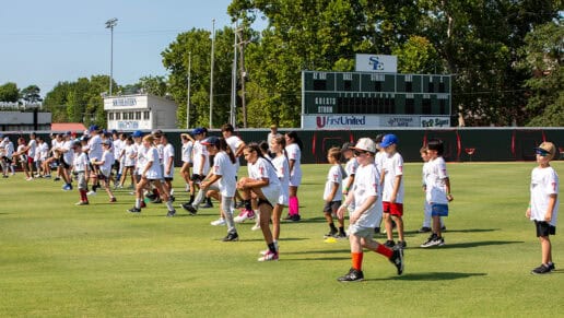 A group of students participating in a warm-up drill at the N7 Diamond Experience.