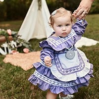 Tinsley Roberts, little girl dressed in a purple Choctaw Dress