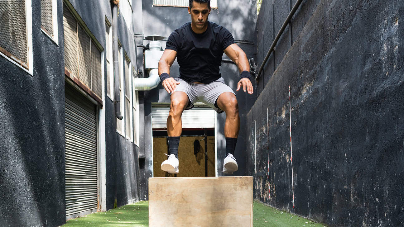 Man using box jumping for functional workouts and movements.