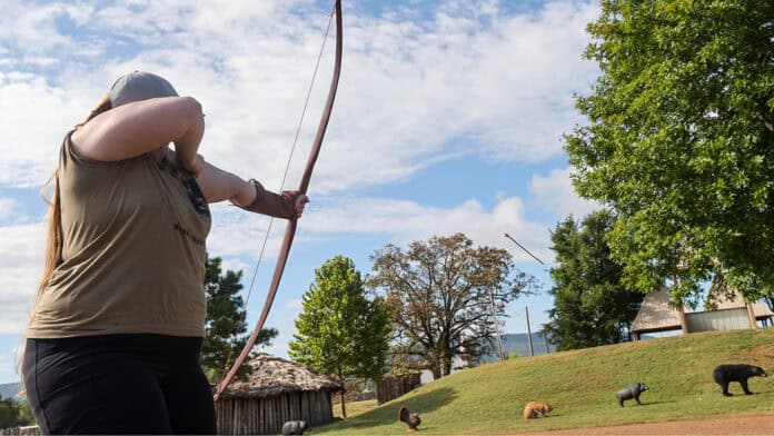 Kelbie Kennedy shoots an arrow at her target during the bow shoot on Sunday morning.