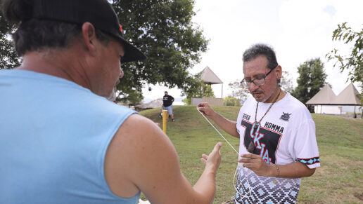 Ramsey Williston demonstrates how to make a stickball ball at the Choctaw Village.