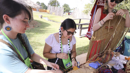 Several women work on traditional textiles.