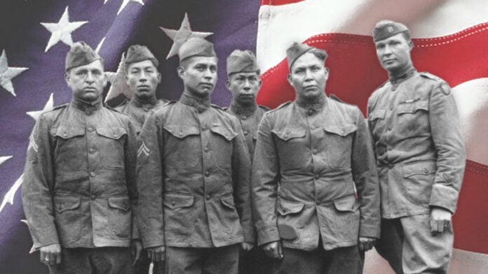 Code Talker standing in front of the US flag.