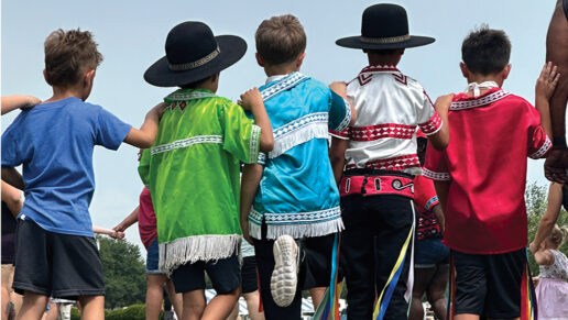 Boys wear traditional choctaw clothing while dancing.