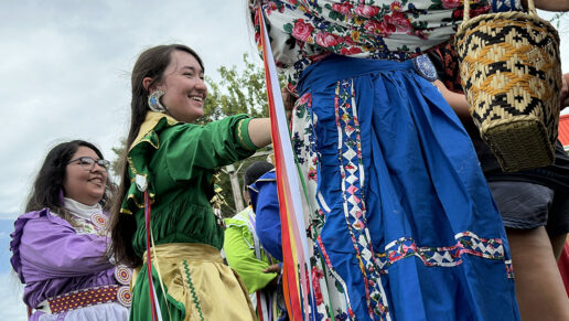 Girls dance in traditional Choctaw clothing.