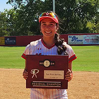 A young woman, Alyssa Langford, wearing a softball uniform holds an award plaque.