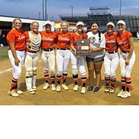 A team of softball players, the Lindsay Leopardettes, pose for the camera.