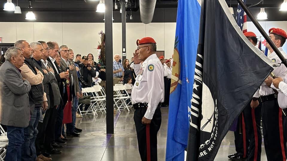 Tribal council hold hands over their hearts as the Honor Guard presents the flags.