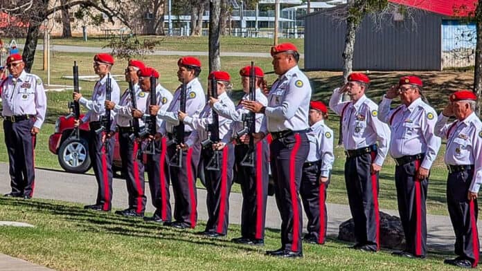 Honor guard lines up with guns for the 21-gun salute.