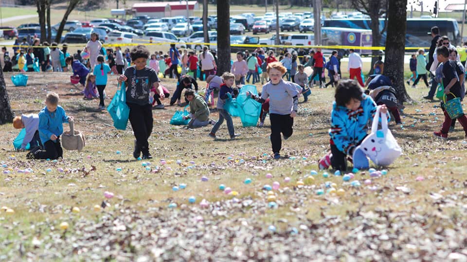 Children run to gather easter eggs.