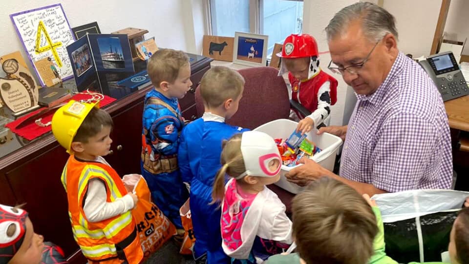 Tribal Council Member Jess Henry hands out candy to trick-or-treaters