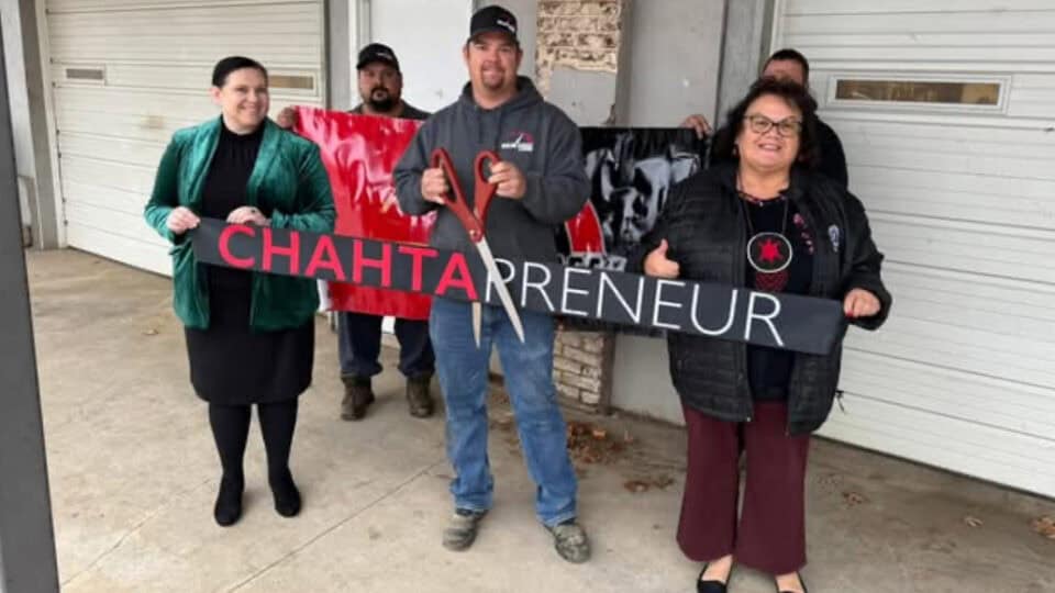 People hold up a ribbon that says Chahtapreneur