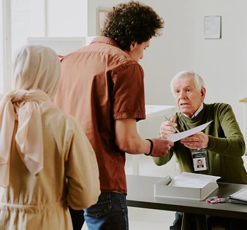 Voting official helping people with their ballot